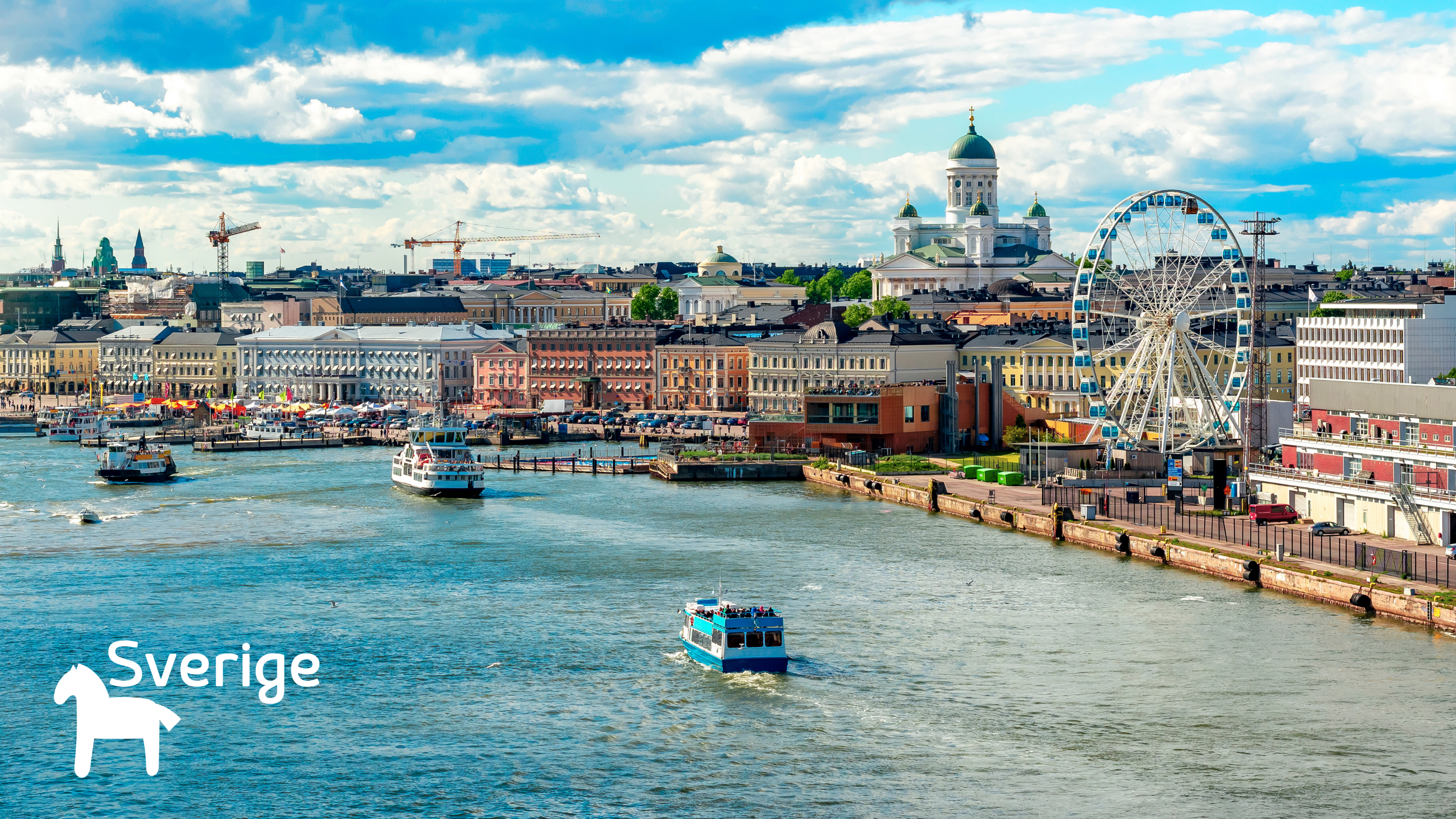 Cityscape with a river, boats, and a Ferris wheel under a blue sky with clouds.